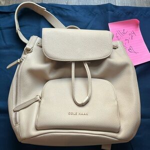 NWOT Cole Haan Classic Flap Backpack in Oat with dust bag. Brand new never used!